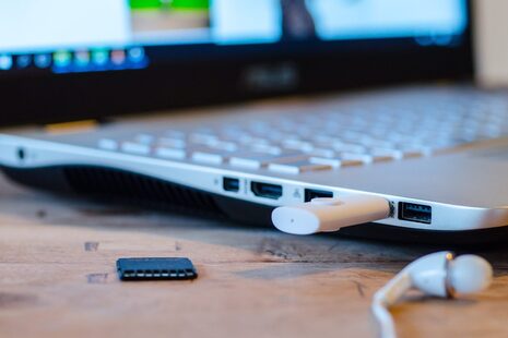 Détail d'une carte mémoire SD et d'une clé USB dans un ordinateur portable
