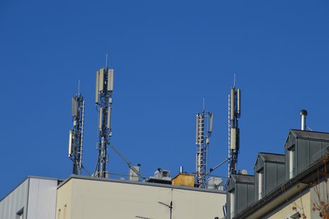 Mehrere Mobilfunkantennen auf einem Hausdach