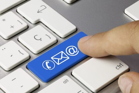 The Enter key on a PC keyboard is labeled with blue symbols for e-mail