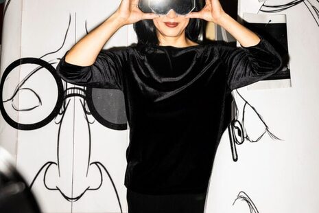 A woman dressed in black with black glasses